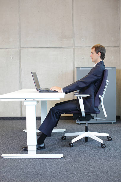 istock man in suit in correct sitting position at workstation 483151760