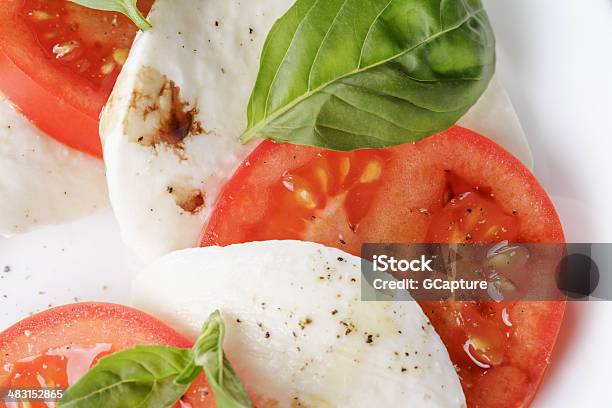 Caprese Salad Made On Cutting Board Stock Photo - Download Image Now - Balsamic Vinegar, Basil, Brown