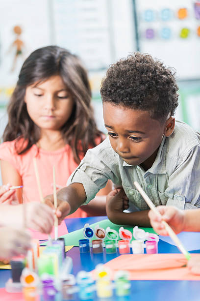 istock Little boy in preschool class doing art project 483154666