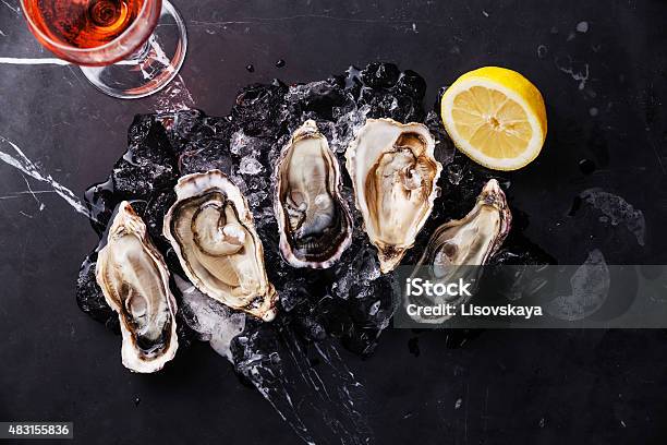 Opened Oysters With Ice Lemon And Wine Stock Photo - Download Image Now - 2015, Animal Shell, Bivalve