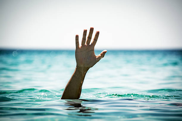 Help! Single hand of drowning man in sea asking for help. drowning photos stock pictures, royalty-free photos & images