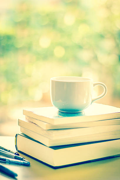 istock selective focus of white coffee cup and  books stacking 483159966
