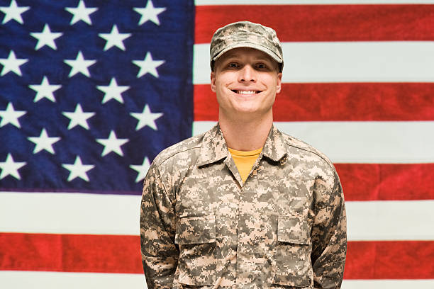 istock Army man standing in front of American flag 483160520