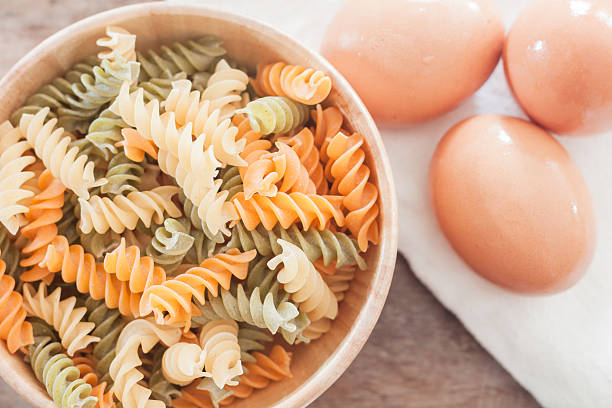 istock Fusili pasta in wooden plate with eggs 483167032