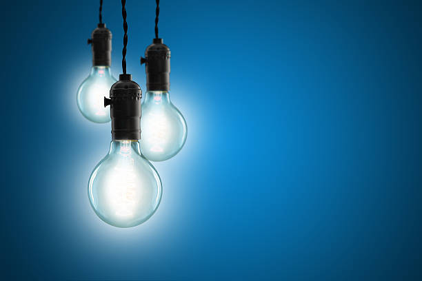 istock Idea concept - Vintage incandescent bulbs on blue background 483167864