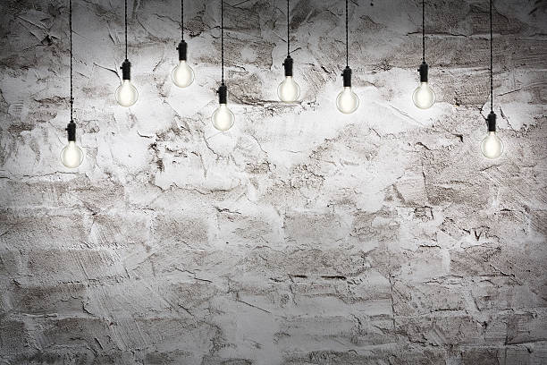 istock Idea concept - Vintage incandescent bulbs on wall background 483167882
