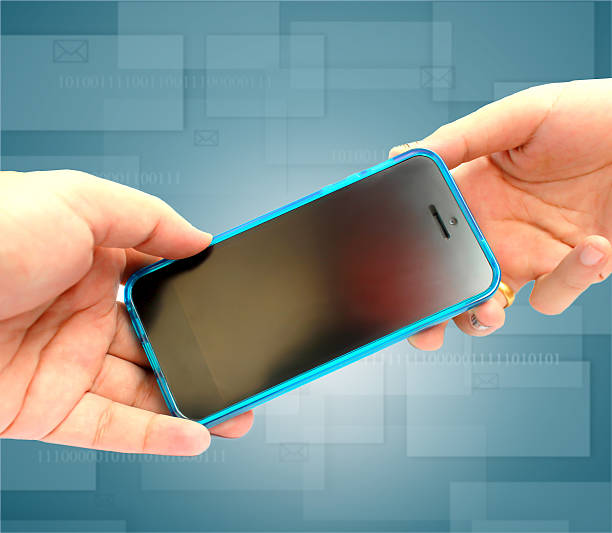 istock Two human hands holding Multimedia phone 483168015