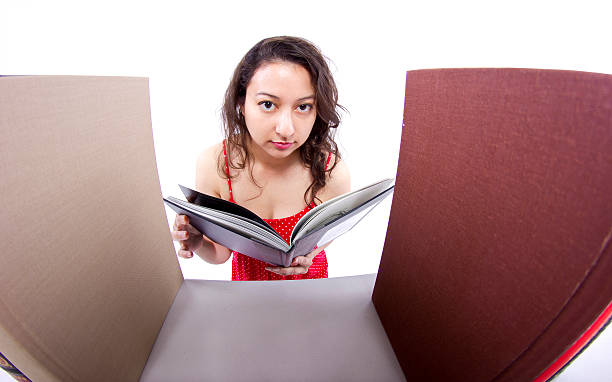 istock Young Female Student Browsing Books on a Bookshelf 483168569