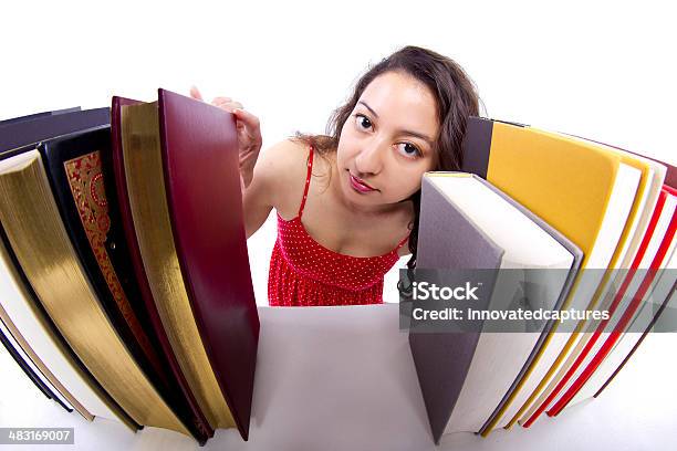 Young Female Student Browsing Books On A Bookshelf Stock Photo - Download Image Now - Adult, Beautiful People, Beautiful Woman