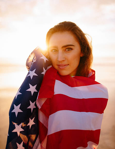 istock Woman with american flag during sunset 483169673