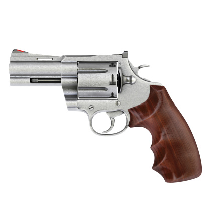 357 magnum revolver on a wooden desk.