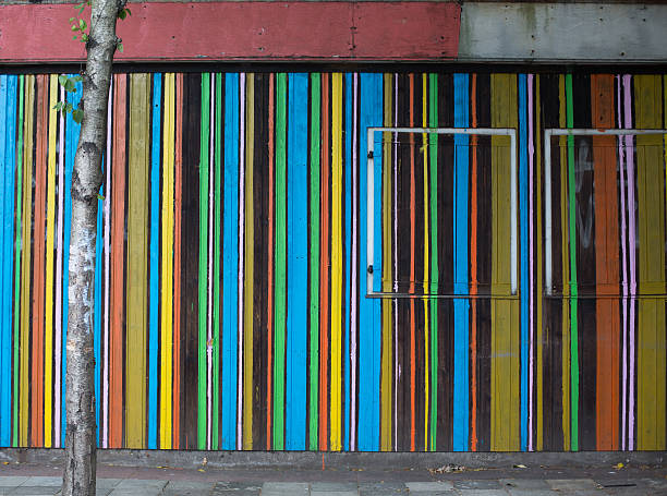 Colourful striped paintwork adorns an abandoned building, Berlin.