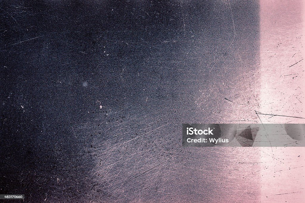 Old grunge filmstrip Blank grained film strip texture background with heavy grain, dust, scratches and light leak Textured Stock Photo