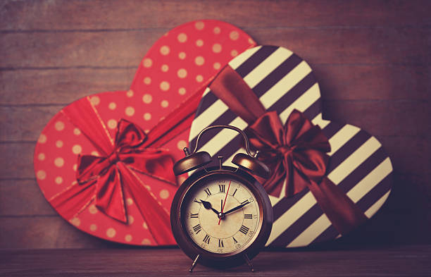 istock Retro clock and gift in heart shape on the background. 483170679