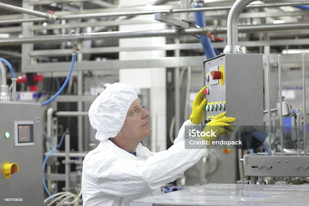 technician at control panel in lab - pressing buttons technician at control panel in laboratory - pressing buttons Laboratory Stock Photo