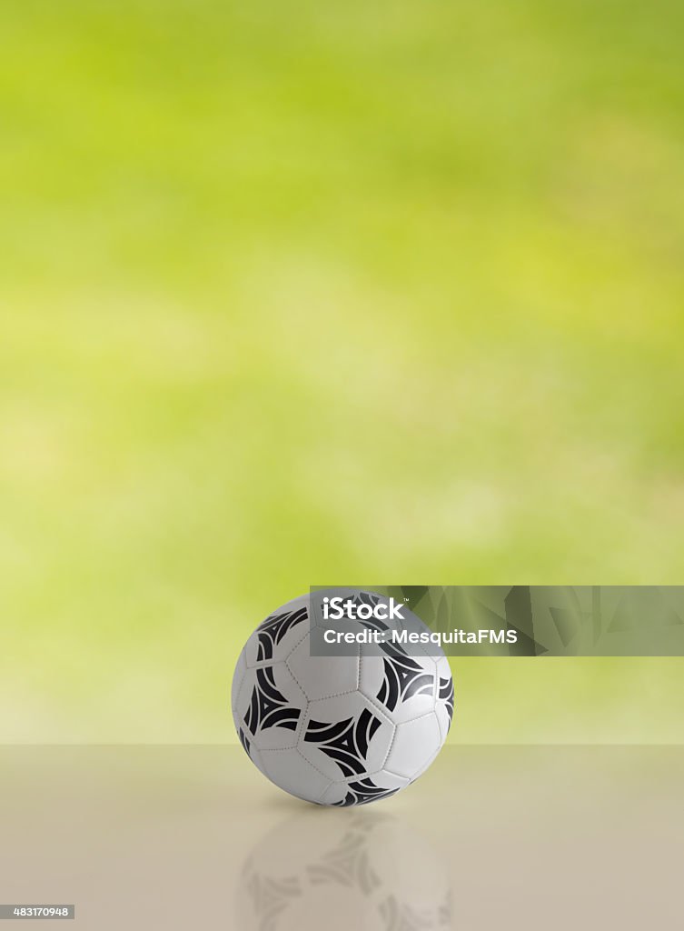 Soccer ball or football ball Soccer ball reflecting on the table in the green background. 2015 Stock Photo