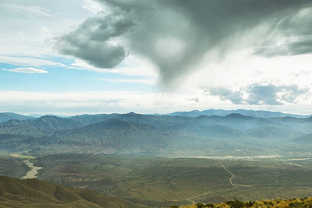 Ash Meadows National Wildlife Refuge, in Amargosa Valley, adjacent to Death Valley, Mojave Desert, Nevada, under a menacing sky with storm clouds and sun rays.