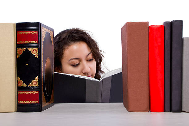 istock Young Female Student Browsing Books on a Bookshelf 483171917