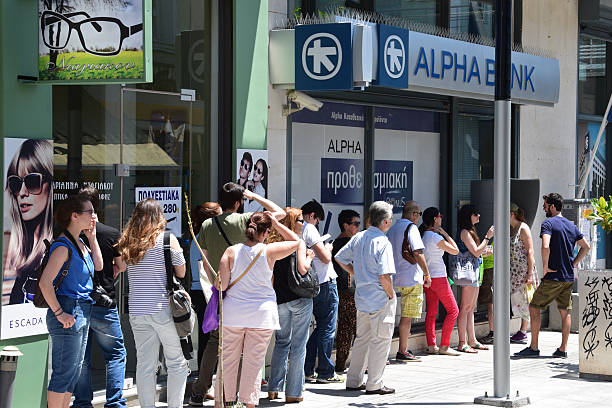 line of people atm cashpoint Athens, Greece - July 1, 2015: Long line of people waiting to withdraw cash money from ATM cashpoint outside a closed bank. Capital controls during greek financial crisis. budget cut stock pictures, royalty-free photos & images