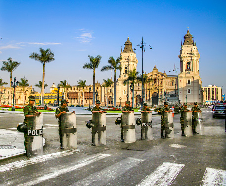 Lima, Peru - January 16, 2015: View of the cathedral church and the main square in the down town. Policemen in uniform protect the place against political demonstrants.