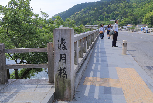 Kyoto Japan - May 6, 2015: People sightsee Togetsu bridge in Arashiyama Kyoto Japan.