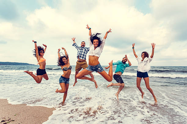 istock Group of friends at the beach jumping for joy 483179728