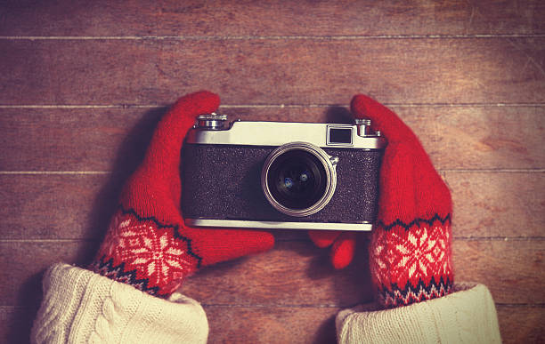 istock Hands in mittens holding vintage camera 483183601