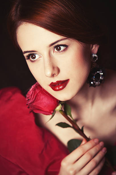 istock Beautiful redhead women with rose. 483184001