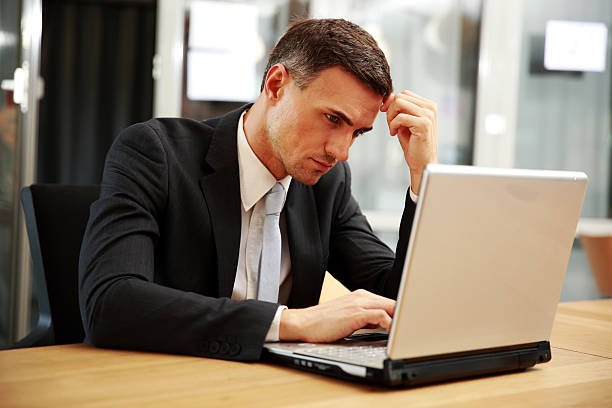 istock Confident businessman sitting with laptop 483184565