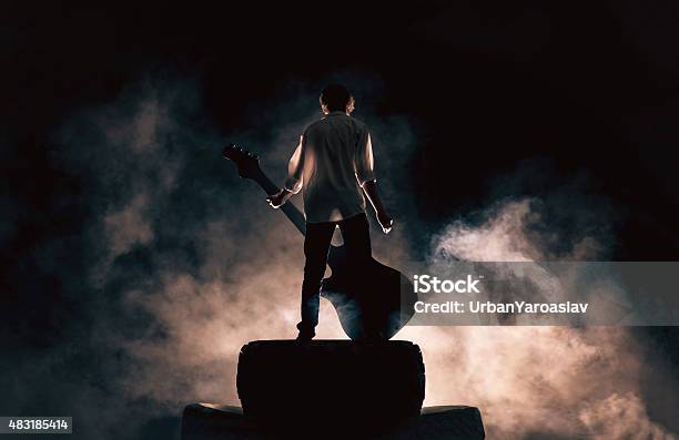 Rock Musician And Large Guitar A Lot Of Smoke Stock Photo - Download Image Now - Stage - Performance Space, Singer, Musician
