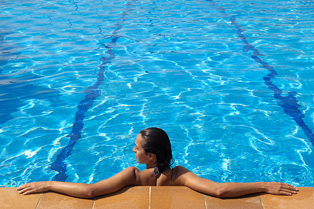 istock woman lounging by the pool 483185554