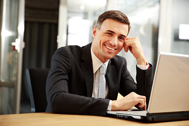 istock businessman sitting with laptop 483186129