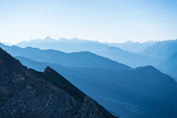 istock Blue toned mountain silhouette at sunrise 483186222