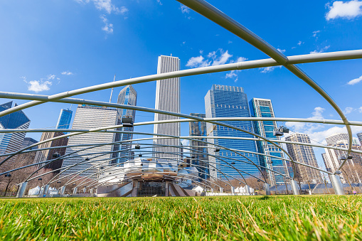 CHICAGO-April 10:Jay Pritzker Pavilion with high modern buildings in winter at Millennium Park on April 10, 2015 in Chicago, IL USA. Pavilion hosts concerts and events by capacity for 11,000 people.