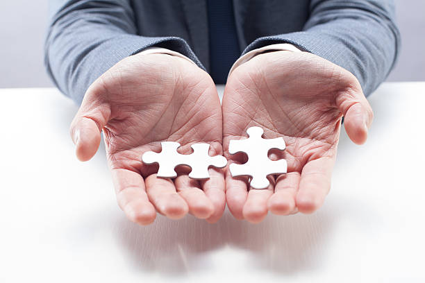 istock Businessman Holding Puzzles 483187089
