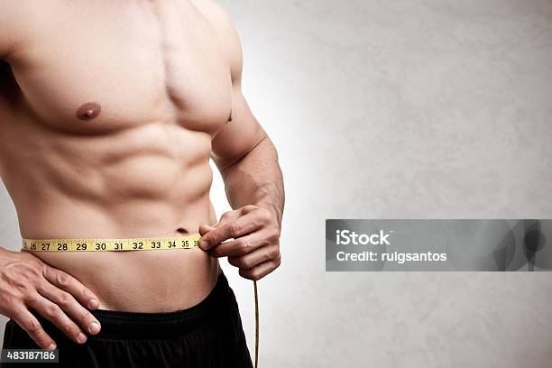Fit Man Measuring His Waist Stock Photo - Download Image Now - Dieting, Men, Loss