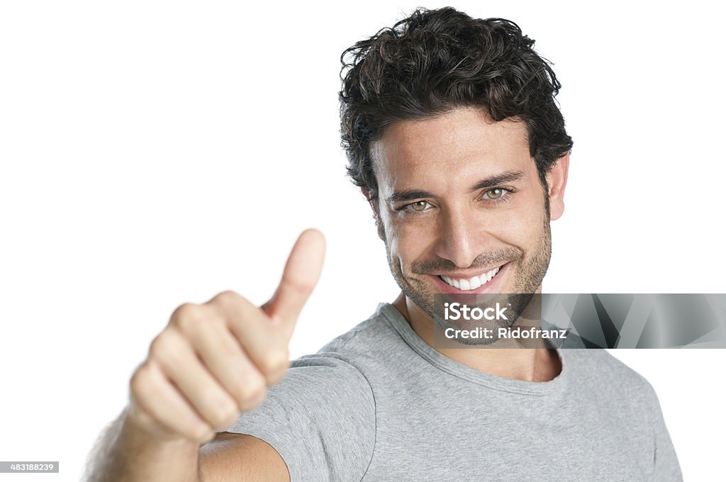 Success and achievement Happy smiling guy showing thumb up hand sign isolated on white background. Men Stock Photo