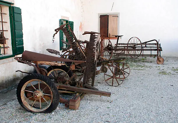 Photo of Antique Harvesters and Horse-Drawn Hay Rakes