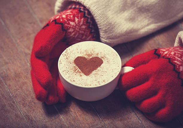 istock Hands in mittens holding hot cup of coffee 483189523