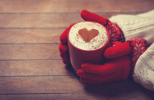 istock Hands in mittens holding hot cup of coffee 483189859