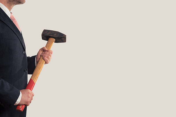 istock Businessman holding a sledgehammer in his hands 483191240