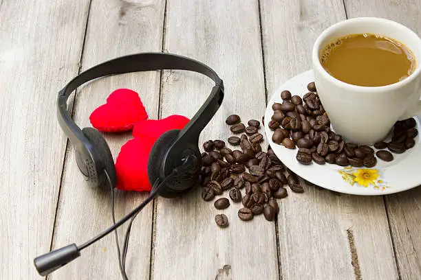 love music,Headphones heart and coffee on the wooden floor