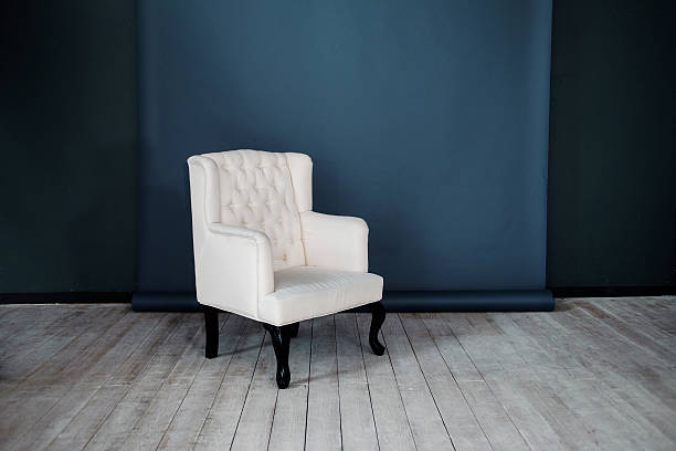 istock One classic armchair against a dark blue wall and floor 483197402