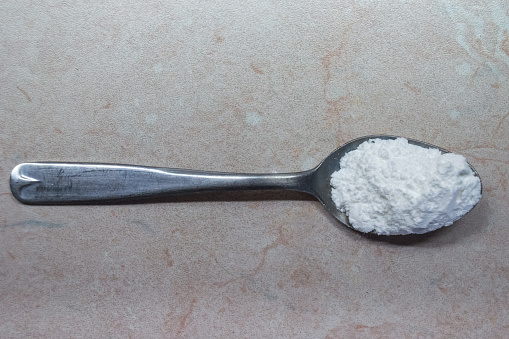 A heaped teaspoon of baking powder, to be used as a leavener in baking, such as baking cakes.