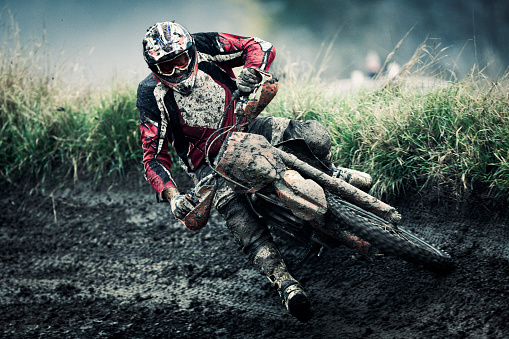 Motocross rider on track, strong grain added to create atmosphere.