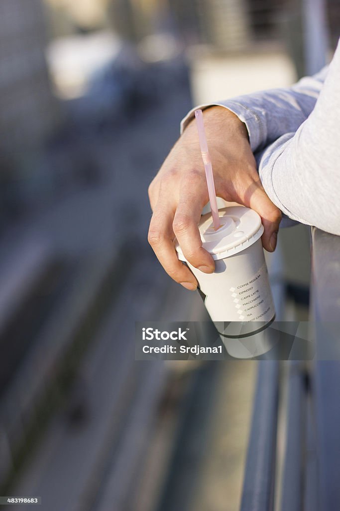 City view, Coffee break Hand holding cup of coffee to go Black Coffee Stock Photo
