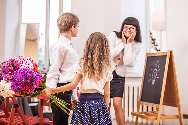 menino e menina crianças dar flores como uma escola professor - learning male studying smiling imagens e fotografias de stock