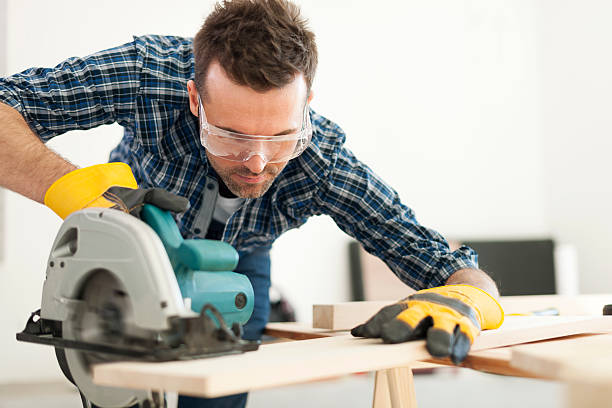 istock Hard working carpenter cutting wooden plank 483199631