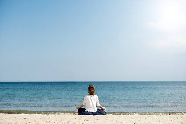 istock Woman meditating at the sea 483199830
