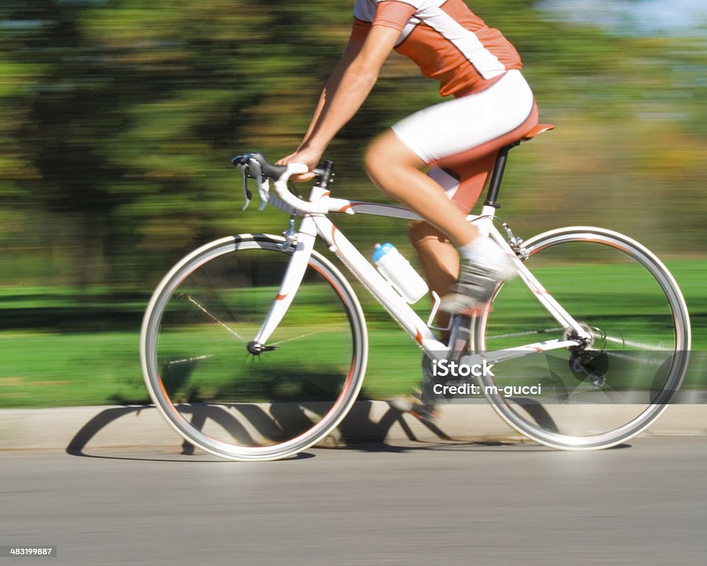 Speeding Cyclist - Blurred Motion Speeding cyclist on the race - blurred motion. Photo has intentional off-focus and slight blur to make a impression of speed and action. Cycling Stock Photo